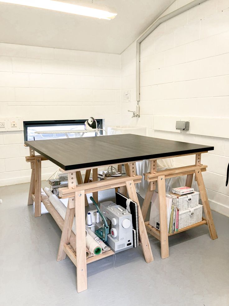 a workbench in a garage with tools and materials on the table for assembly