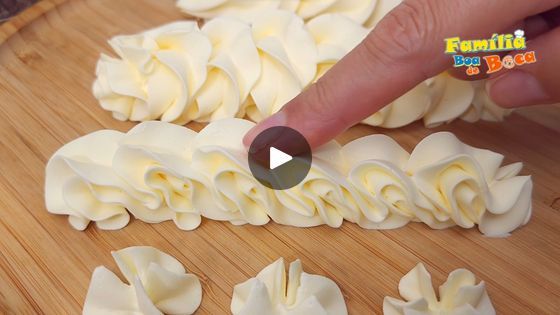 someone is making dumplings on a cutting board and pointing at them with their finger