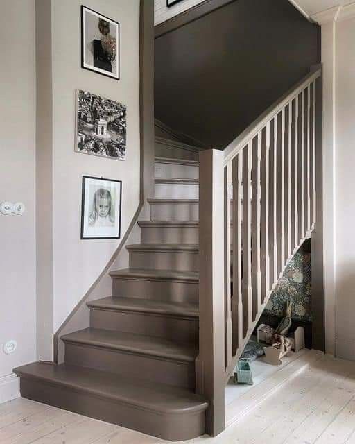 there is a staircase with pictures on the wall