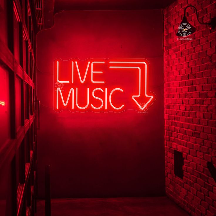 a red neon sign that says live music in the middle of a room with bookshelves