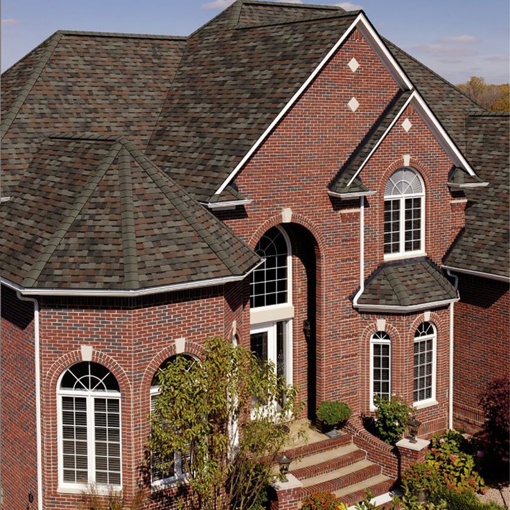 a large brick house with two story windows