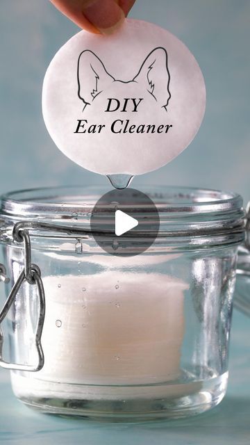 a person is holding a glass jar with a label on it that says diy ear cleaner