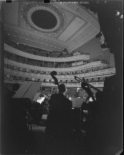 an auditorium filled with lots of people and musical instruments