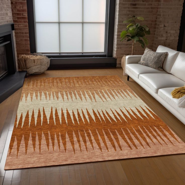 a living room with a white couch and brown rug