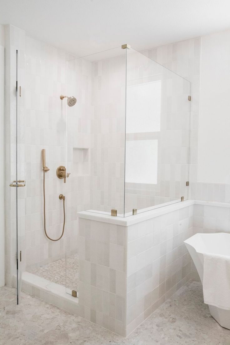 a bath room with a stand up shower and a tub