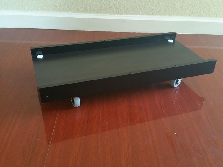 a black tray sitting on top of a hard wood floor