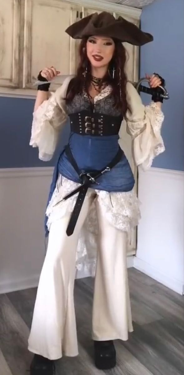 a woman dressed as a pirate posing for the camera