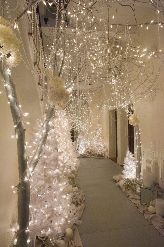 a hallway decorated with white lights and trees