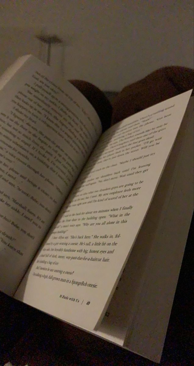 an open book sitting on top of a bed