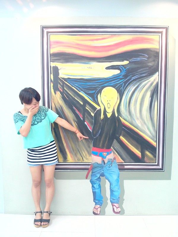 two people standing in front of a painting with one person touching the other's hand