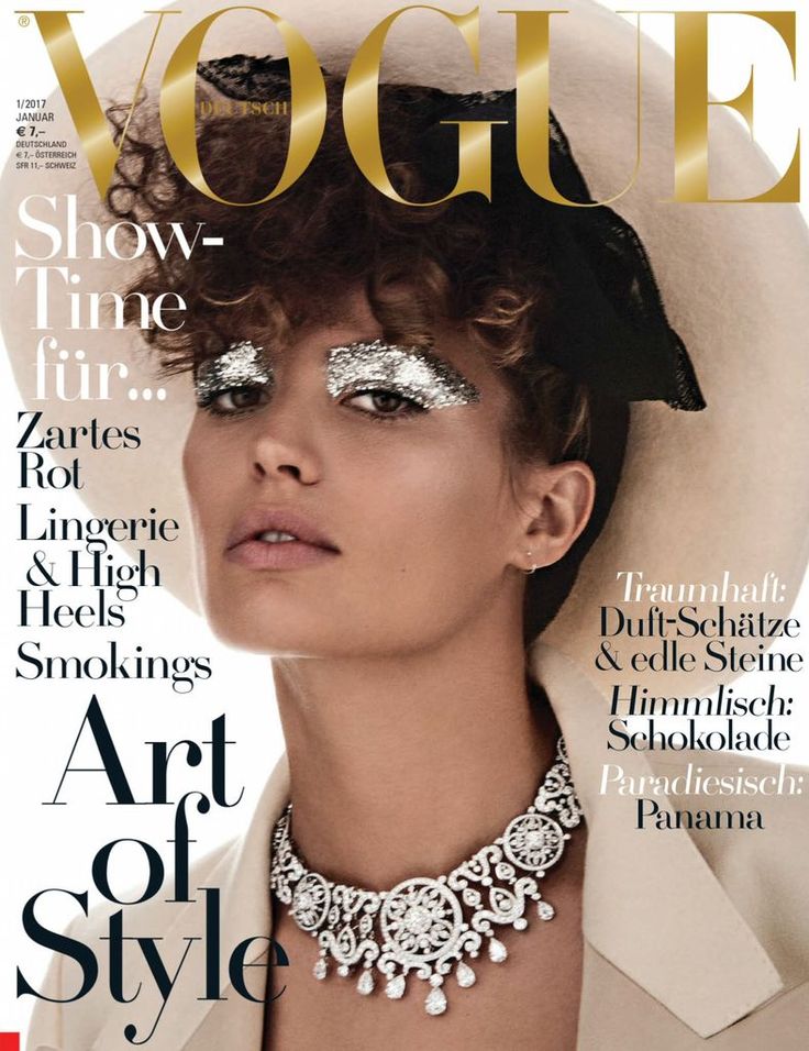 a woman with silver makeup on the cover of a magazine, wearing a white hat