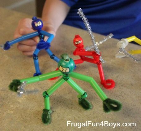 three toy figures are shown in the shape of people with arms and legs holding hands