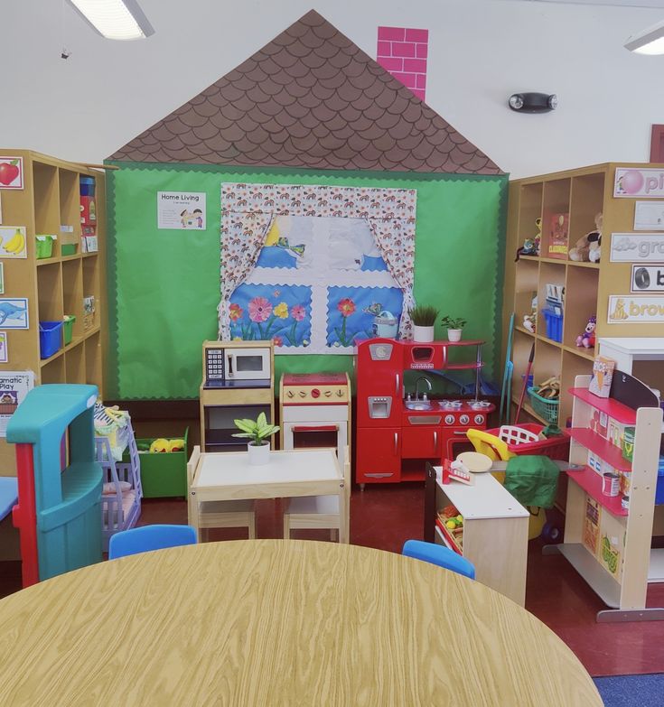 a child's playroom with toys and desks in the corner, including a microwave