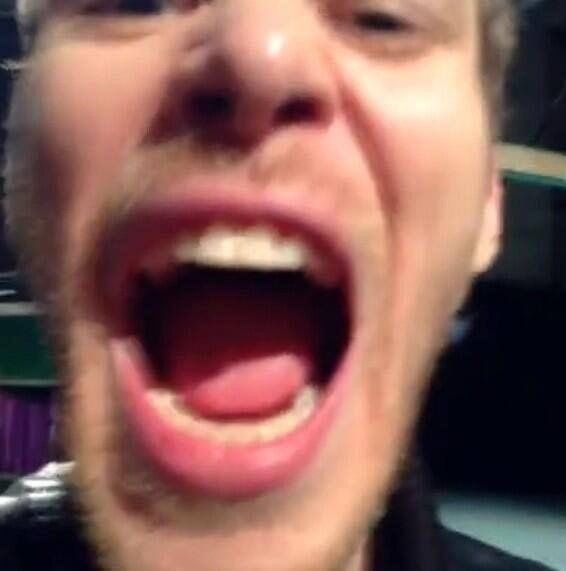 a man with his mouth open and toothbrush in front of him