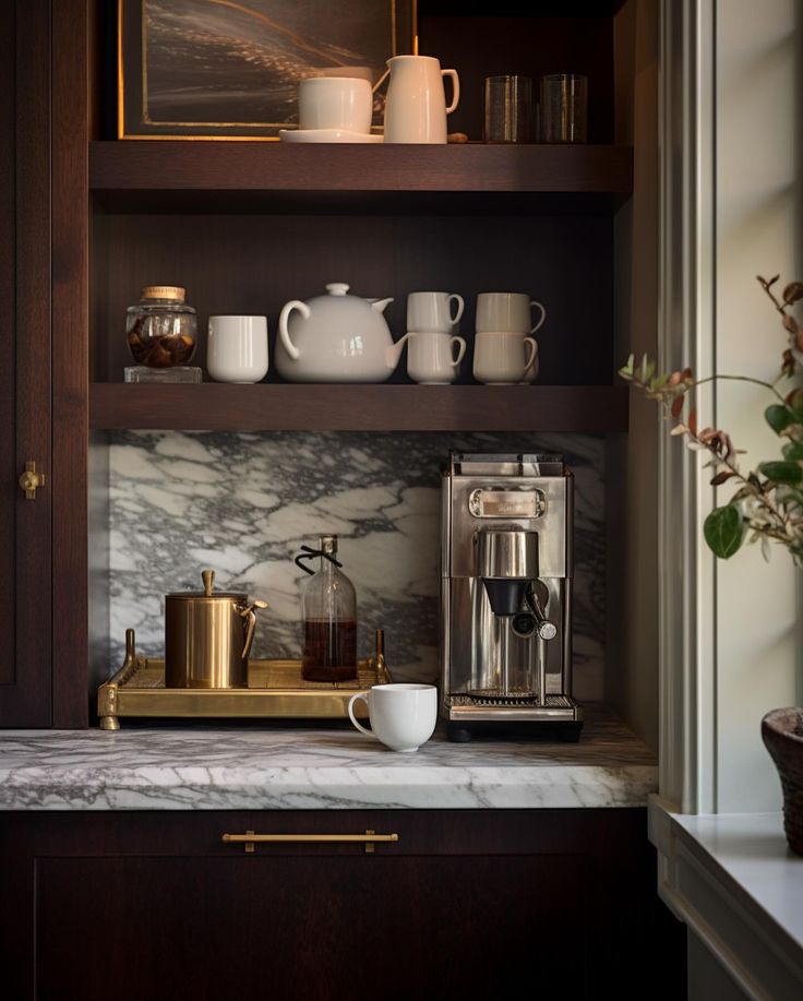 a coffee maker and cups are on the counter in this small kitchen with dark wood cabinets