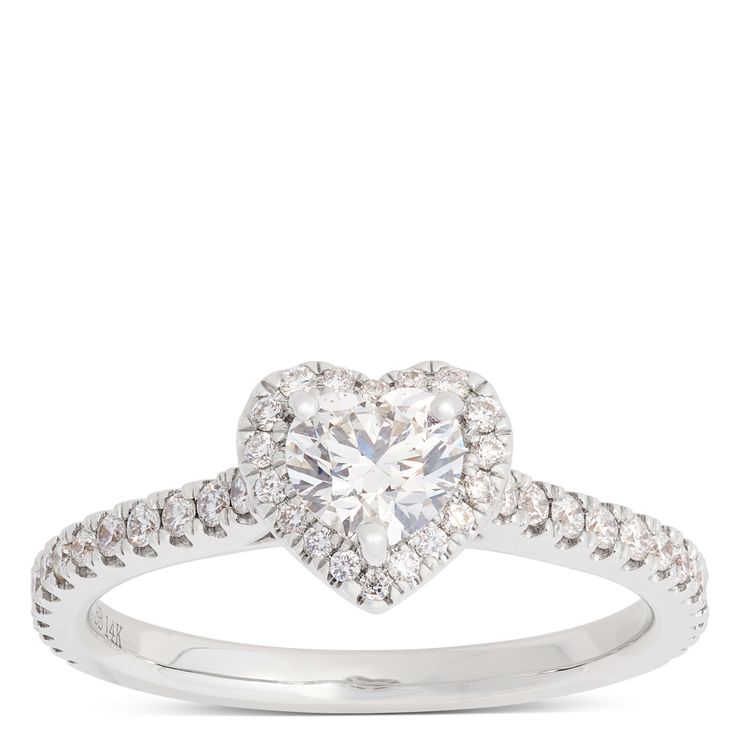 a heart shaped diamond ring with diamonds on the band and an open halo setting in white gold