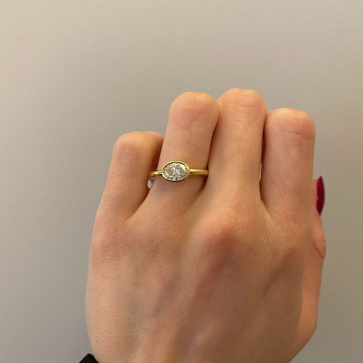 a woman's hand with a diamond ring on it