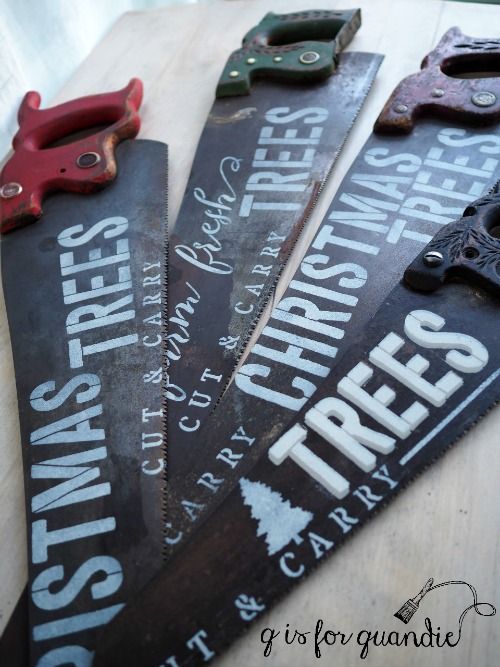 there are three wooden signs that say trees and they have scissors on top of them