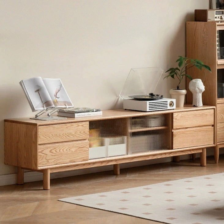 a living room with a book shelf, record player and other items on top of it