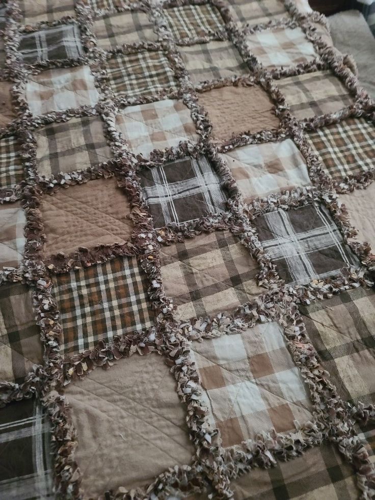 a bed with a brown and white checkered bedspread on top of it