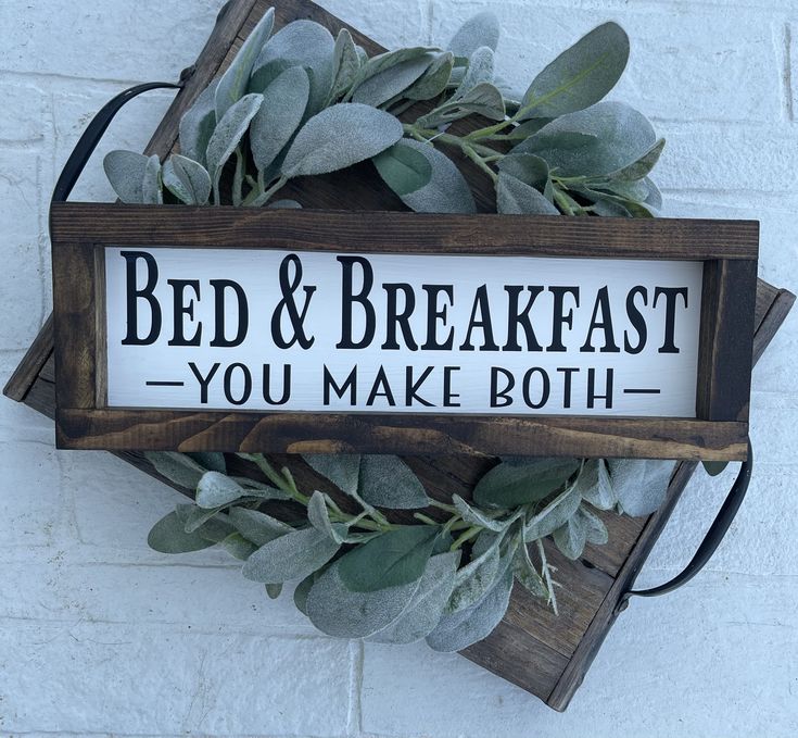 a sign that says bed and breakfast you make both on the side of a brick wall