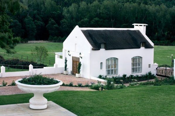 a large white house with a black roof