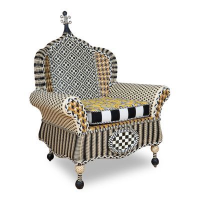 an upholstered chair with black and white patterns