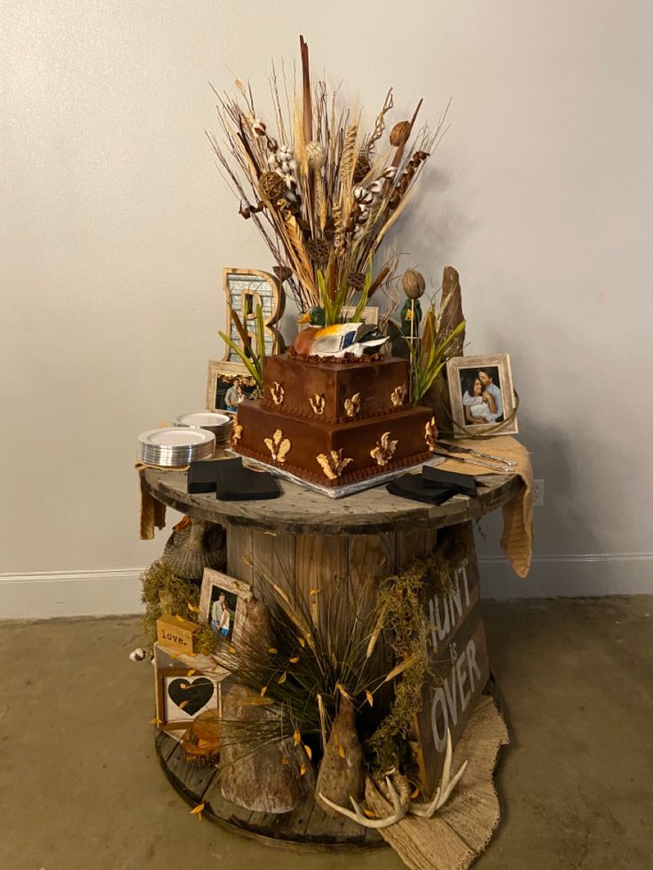 there is a wooden table with pictures and plants on it, along with other items