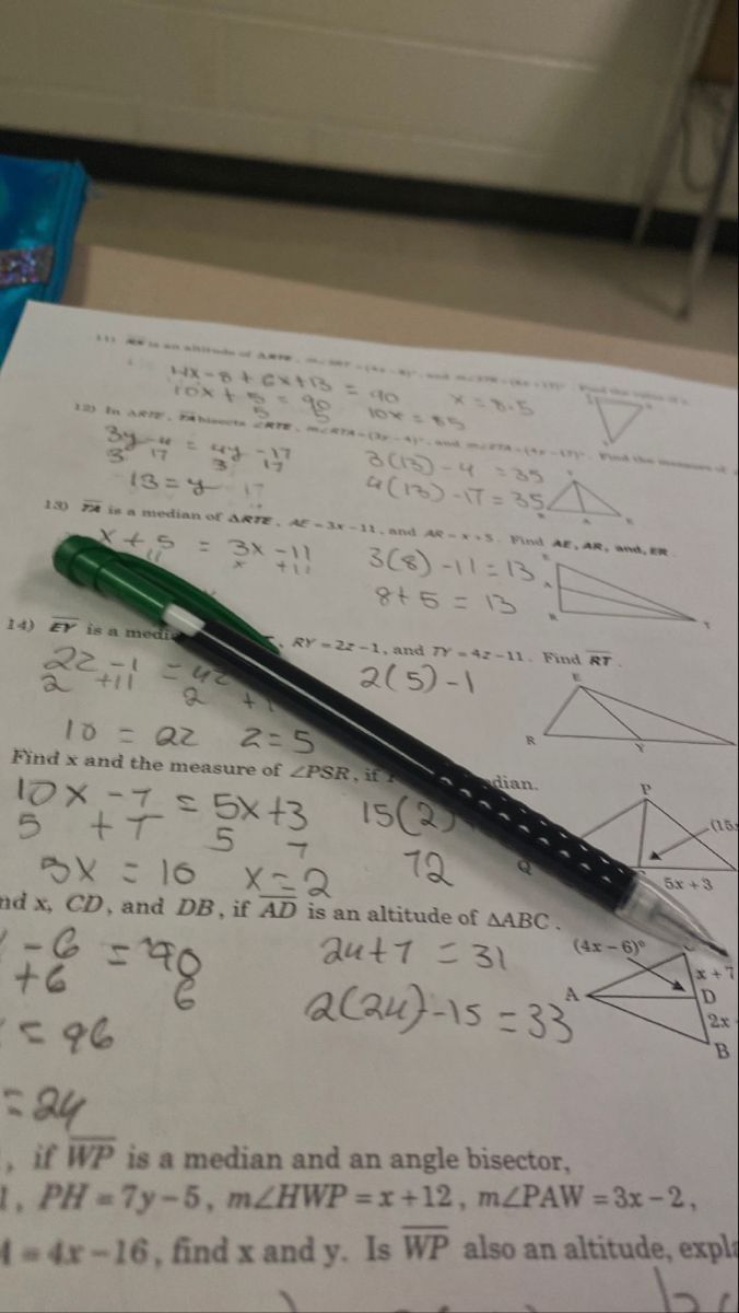 a pen sitting on top of a piece of paper next to a calculator