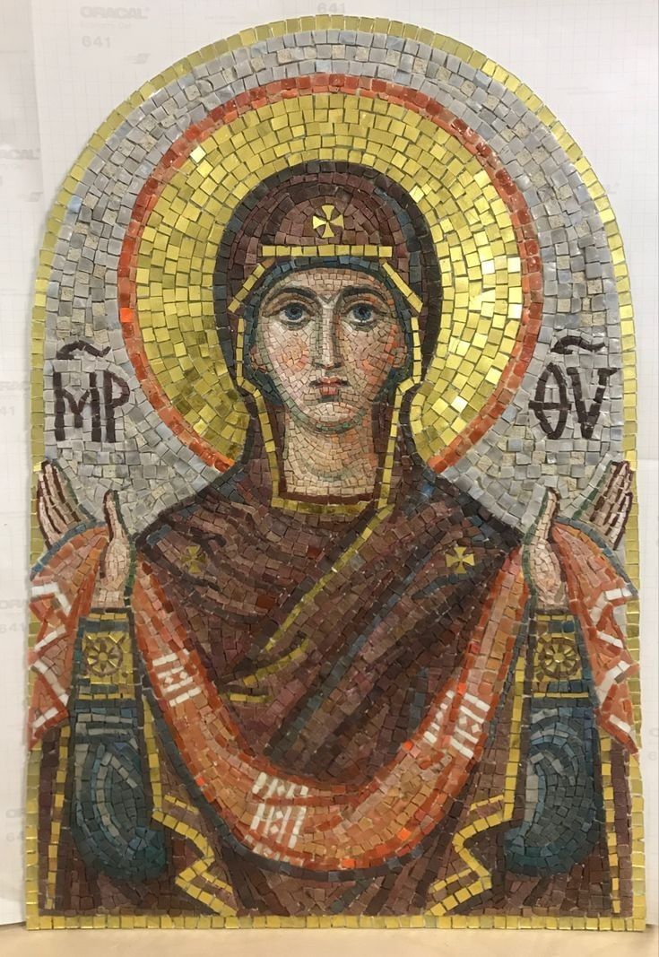 the mosaic portrait of mary magdalene is displayed in front of a white wall with gold and red accents