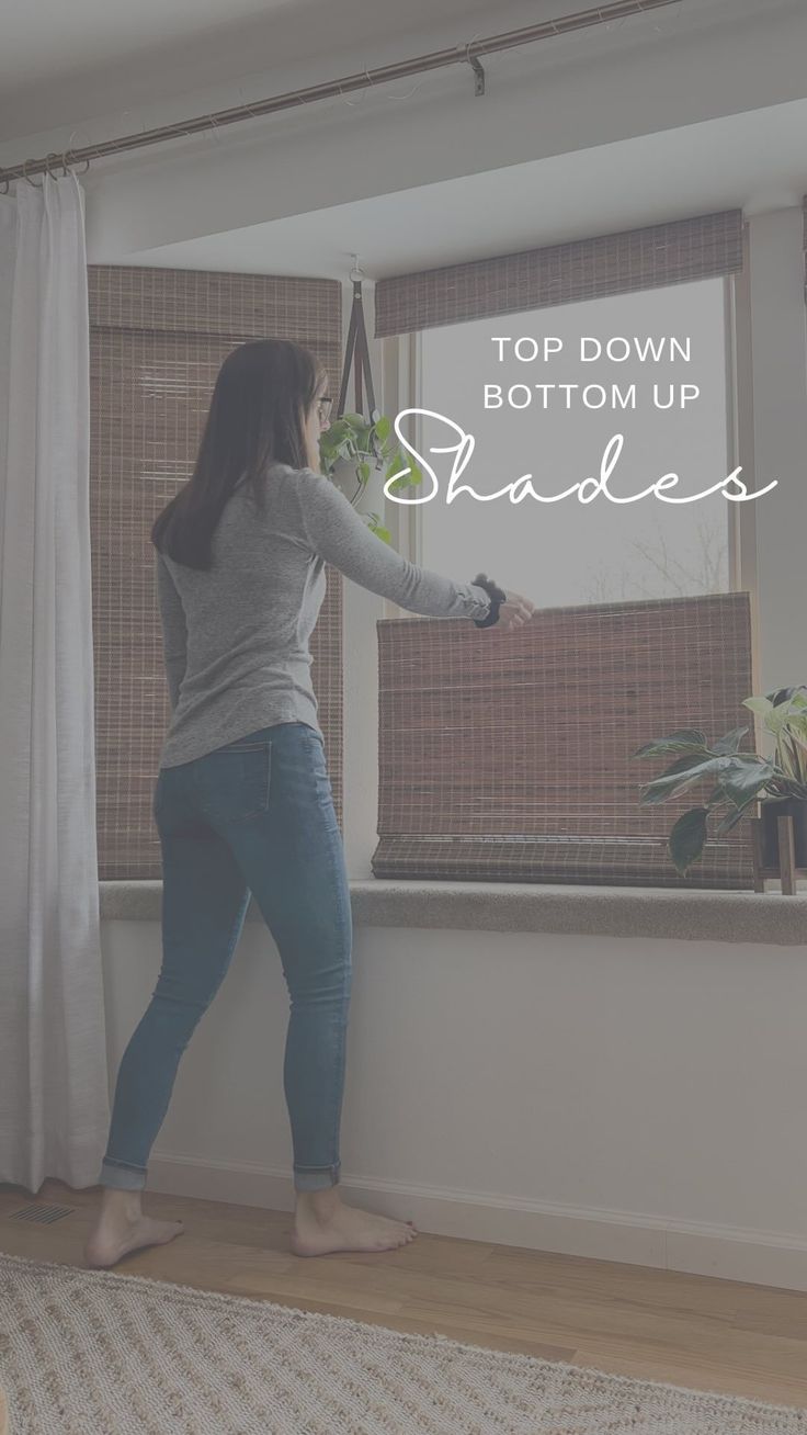 a woman standing in front of a window with the words top down bottom up shades