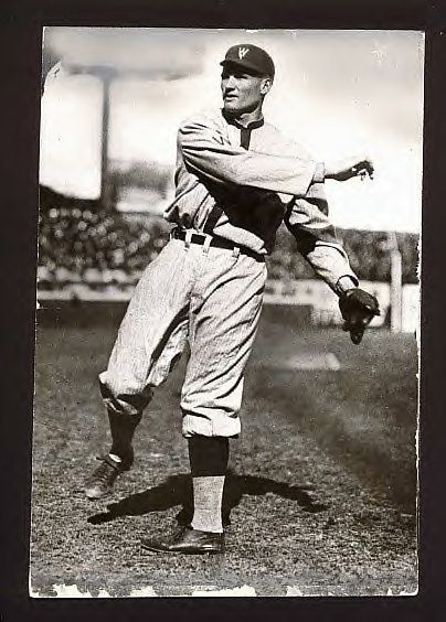 an old black and white photo of a baseball player