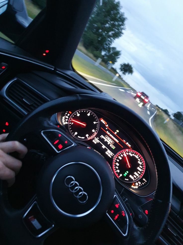 the dashboard of an audi car with red and green lights