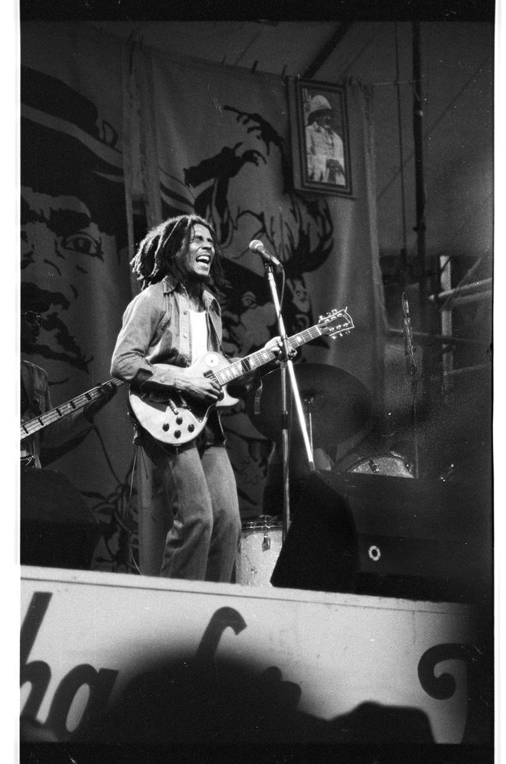 a man that is standing up with a guitar