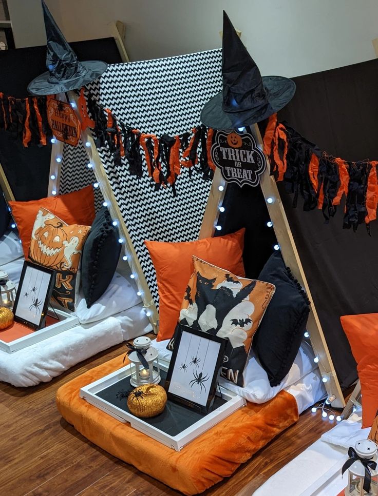 halloween decorations are on display in front of a black and white backdrop with orange accents