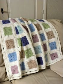 a crocheted blanket sitting on top of a couch