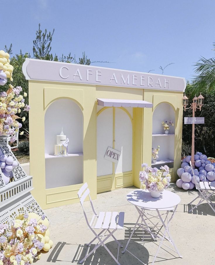 an outdoor cafe with tables and chairs in front of the building that says cafe amenah