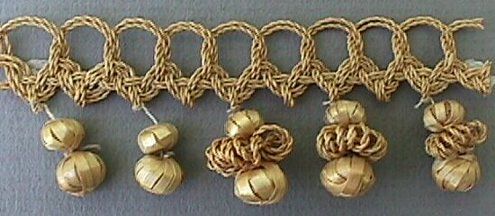 several pieces of gold colored rope with balls attached to them