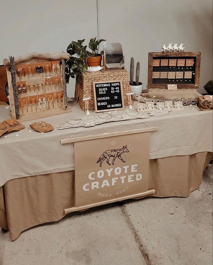 a table topped with lots of food and desserts next to a sign that says coyote crafted