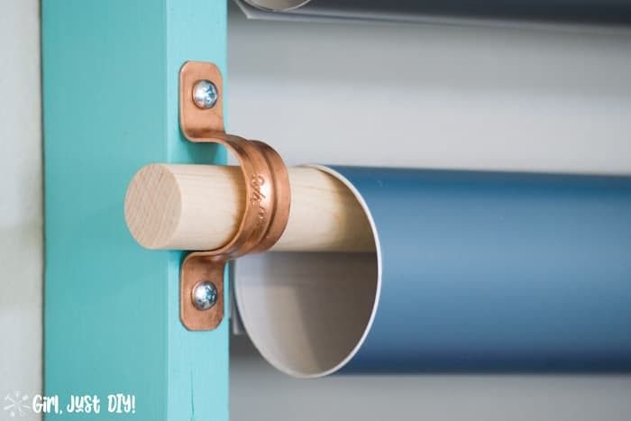 a close up of a blue and white wall with a wooden handle on the door