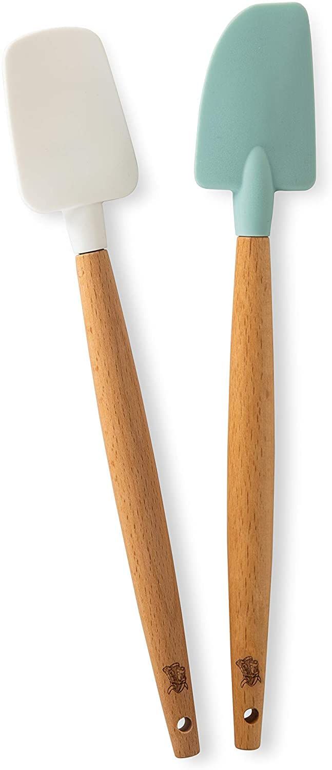 two spatulas with wooden handles on each side, one blue and the other white