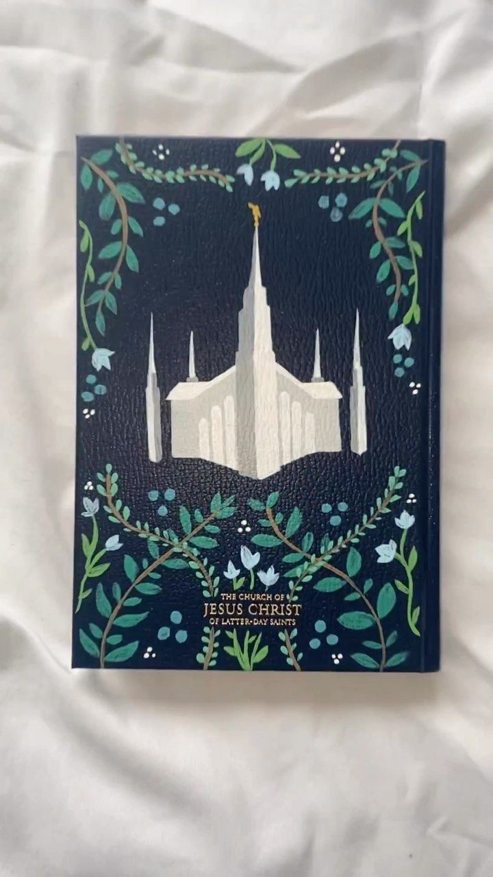 the front cover of a book with an image of a church on it, surrounded by leaves and flowers