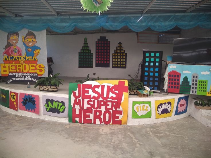 an outdoor stage set up for a children's play area with signs and decorations