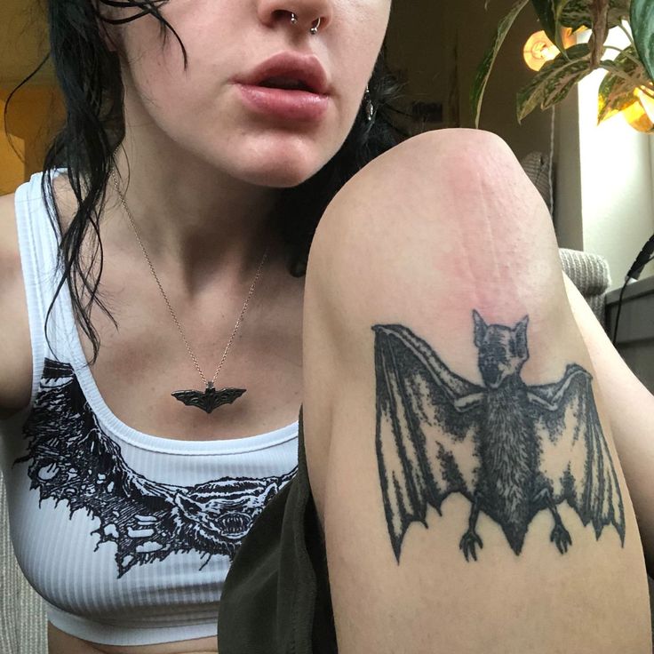 a woman with a bat tattoo on her arm