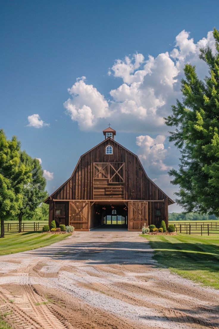 a large barn with a clock on the top of it