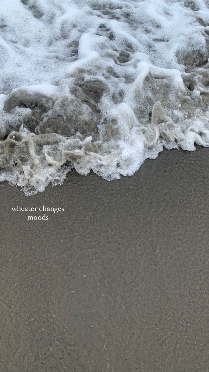 the water is foamy on the sand at the beach