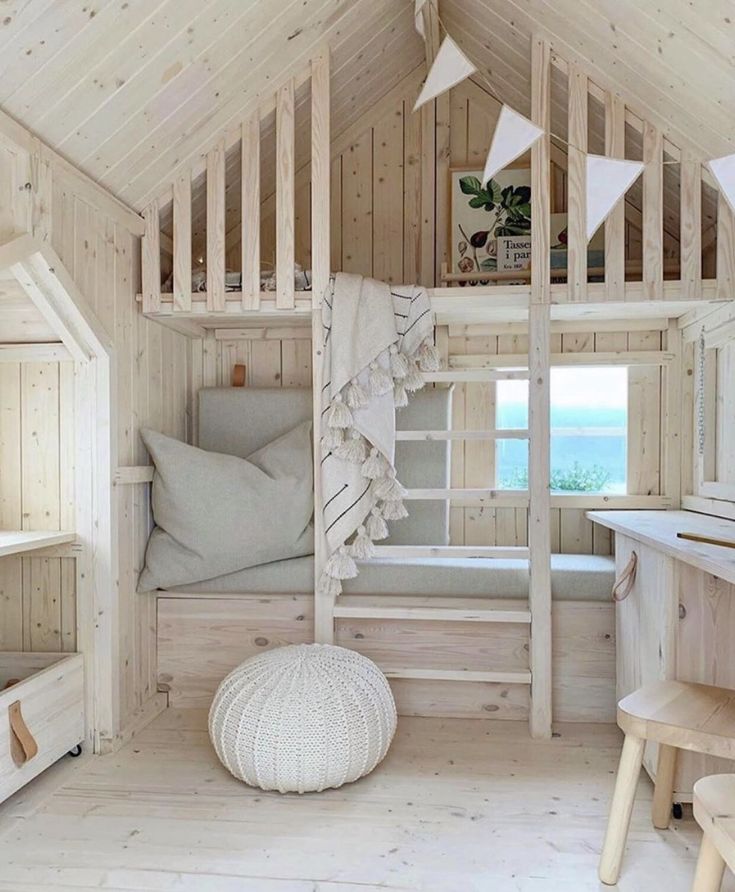 a bedroom with wooden walls and flooring next to a bed in a loft style room