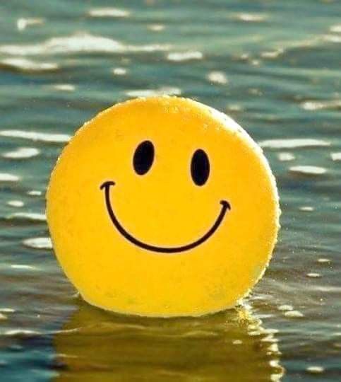 a smiley face ball floating in the water