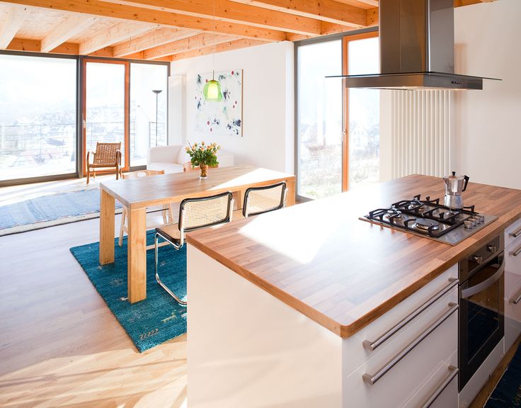 a kitchen with a stove top oven next to a dining room table