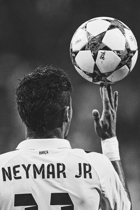 a black and white photo of a man holding a soccer ball in his hand while wearing a jersey that says neymar jr